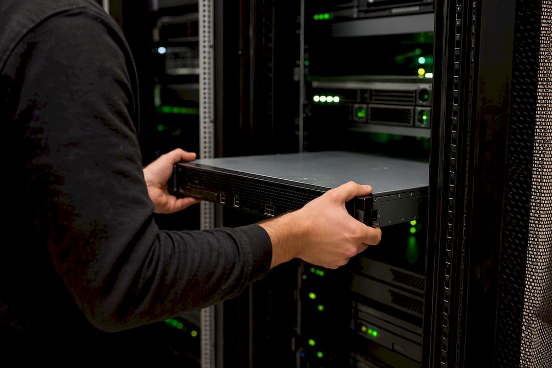 Hands adjusting load balancer in server rack