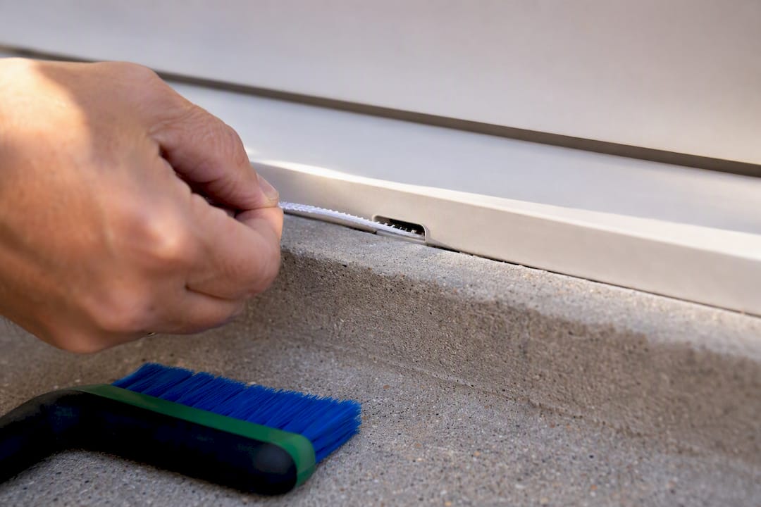 Pipe cleaner clearing a window weep hole