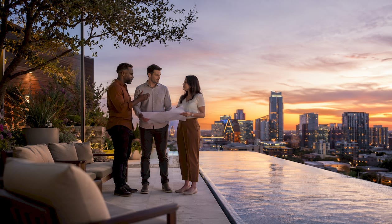 Commercial developers discussing rooftop infinity edge pool view