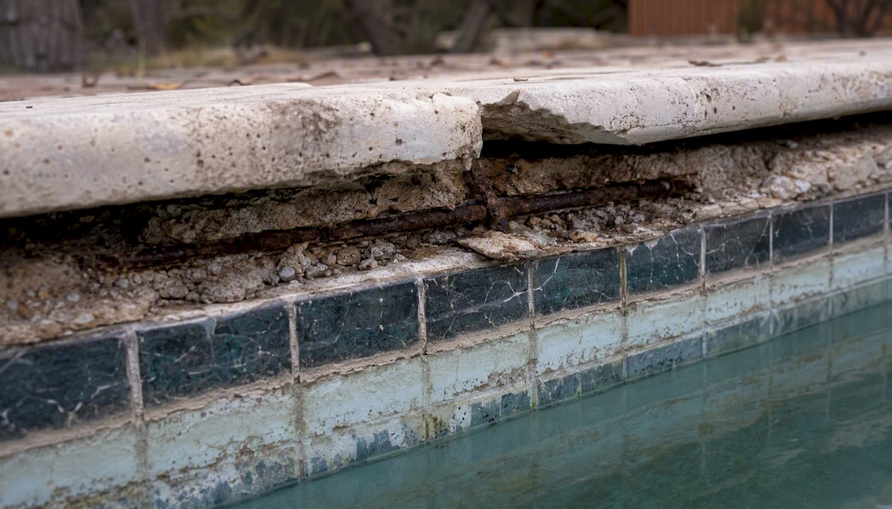 Eroded bond beam and cracked pool coping