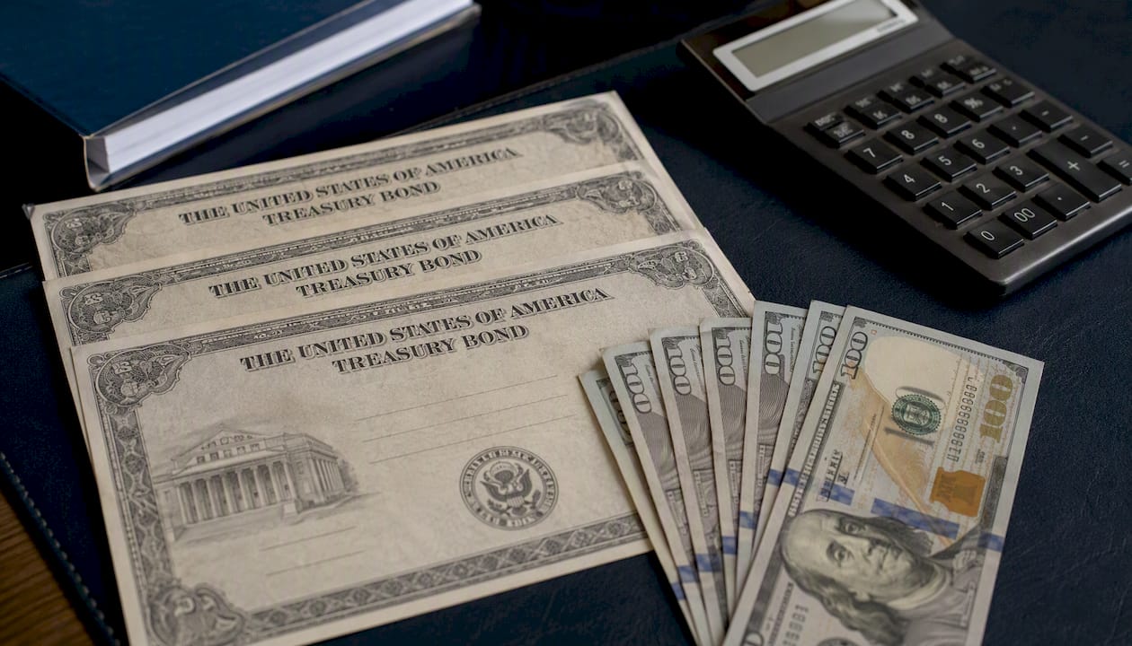 Cash and treasury bonds on matte black table