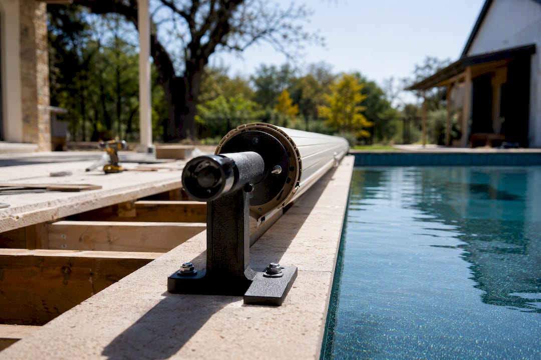 Pool cover reel system installed at pool deck