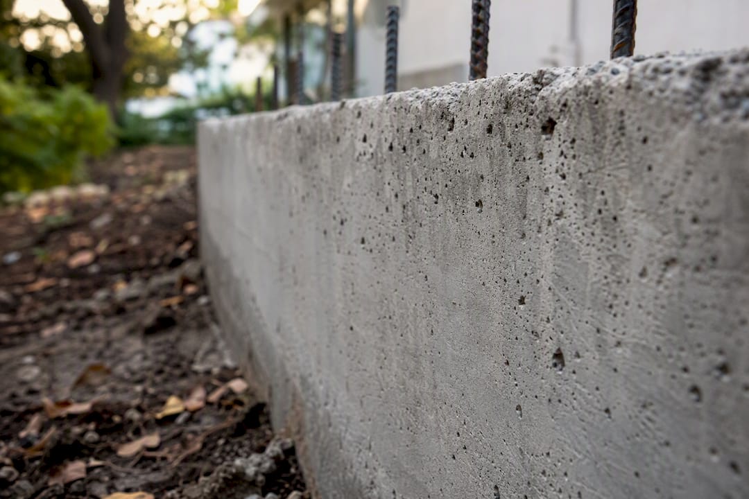 Close-up of poured concrete retaining wall texture and rebar
