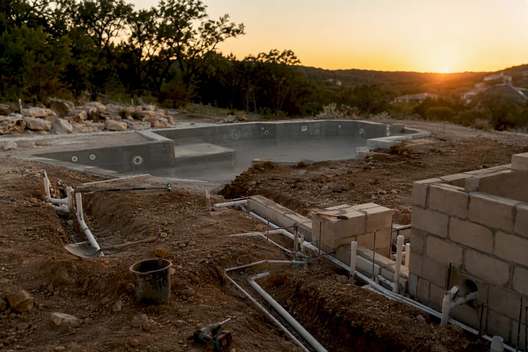 Backyard pool excavation with outdoor kitchen rough-in