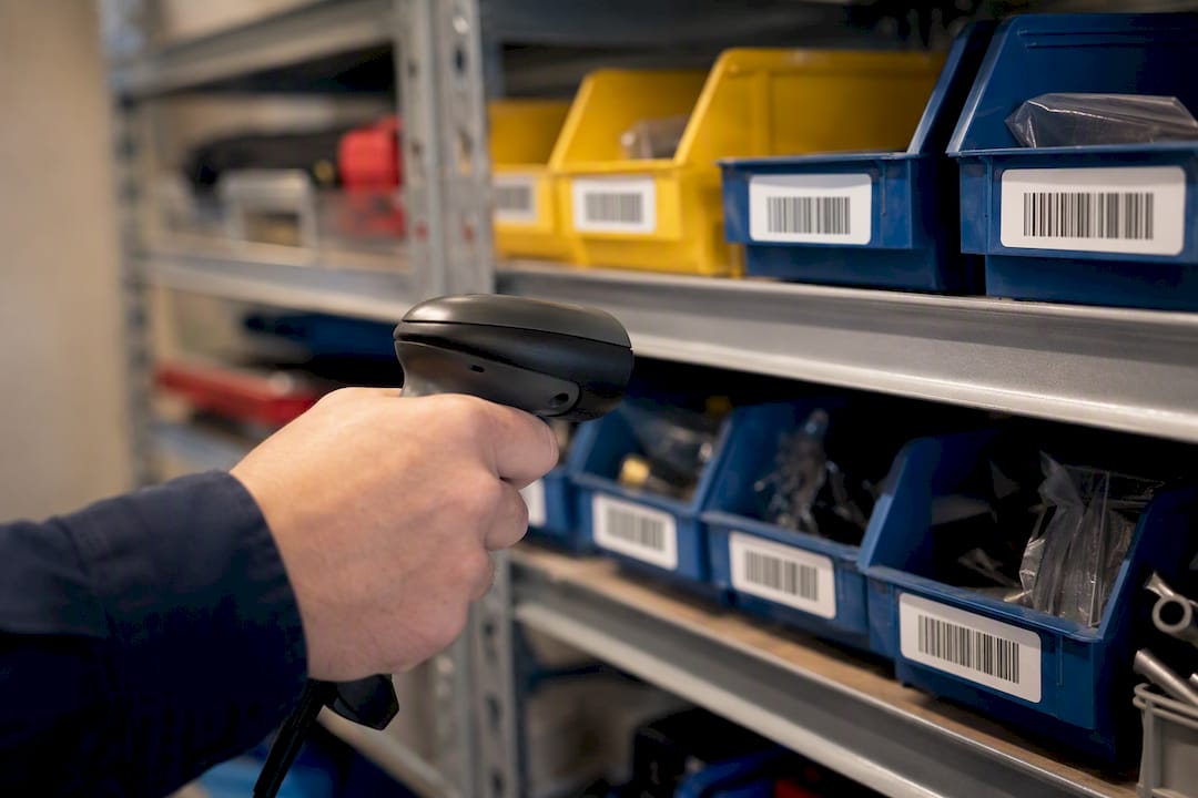 Hand scanning barcode on parts bin