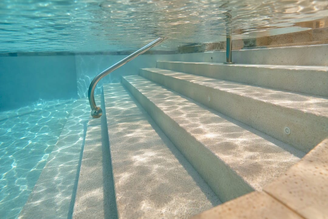 Wide submerged steps in compact plunge pool