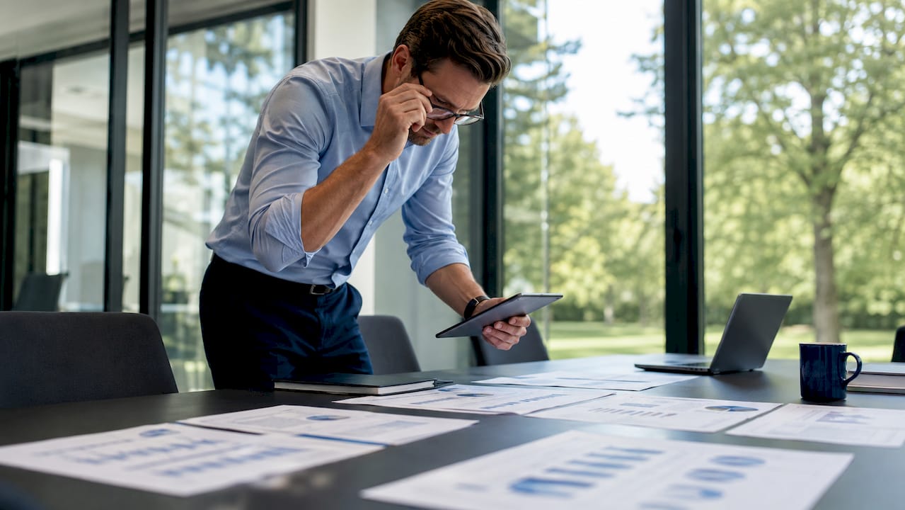 Fleet manager reviewing productivity data at desk