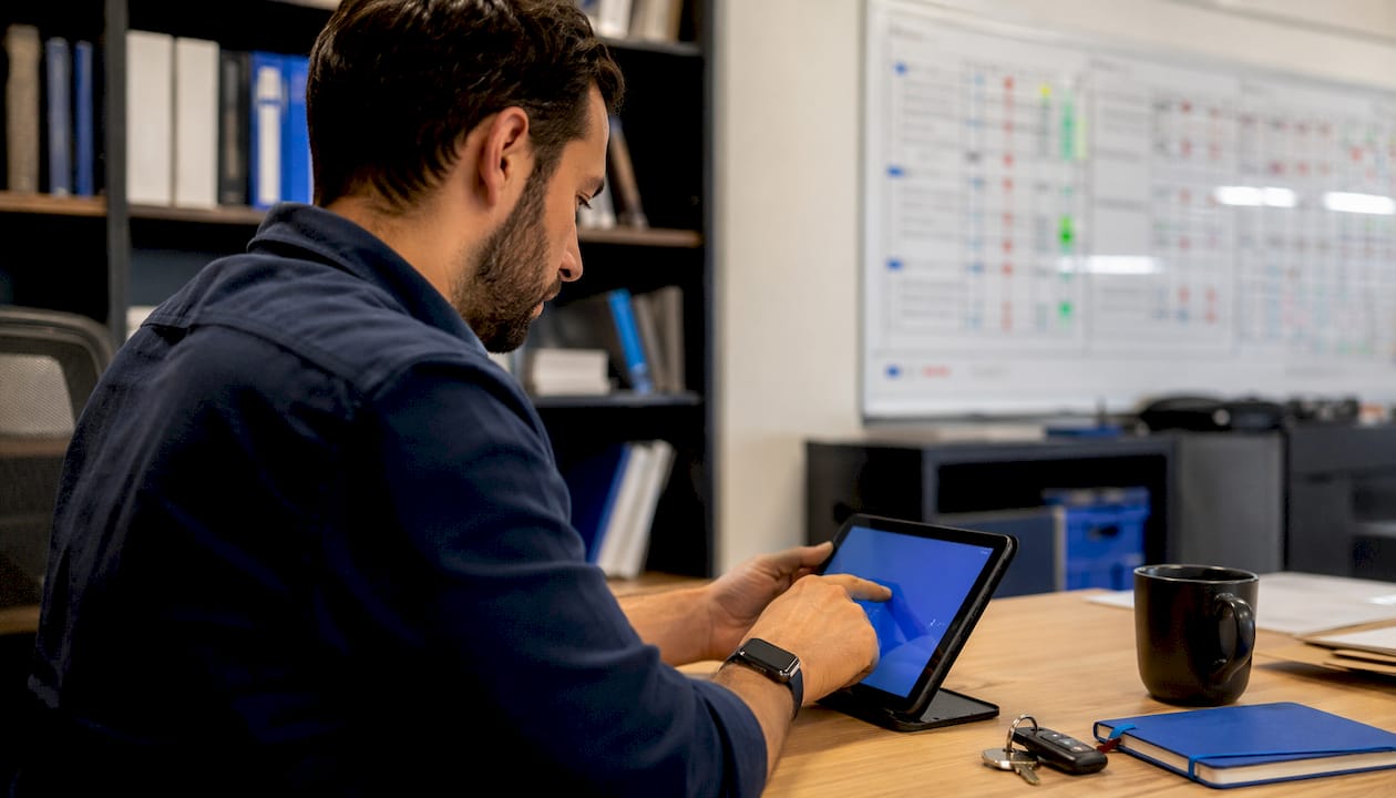 Hands entering telematics data on touchscreen tablet