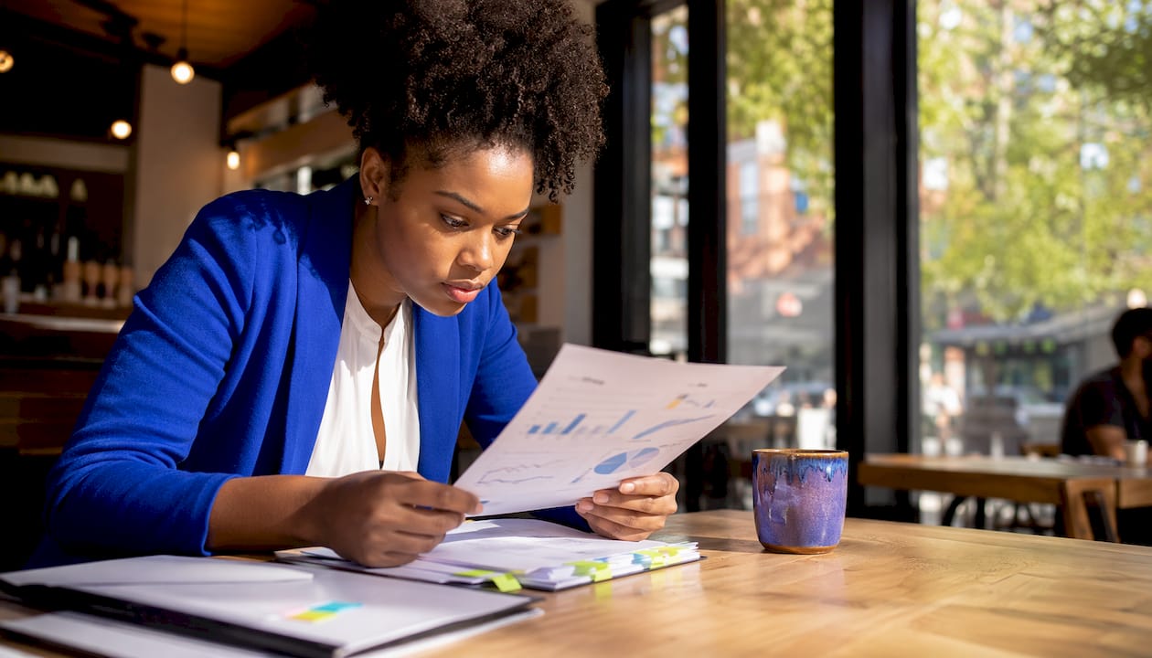 Woman reviewing AI automation balance in meeting room