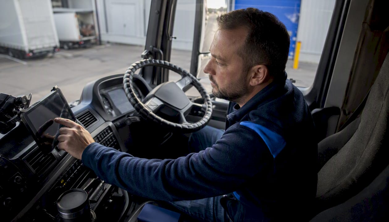 HGV driver interacting with in-cab coaching device