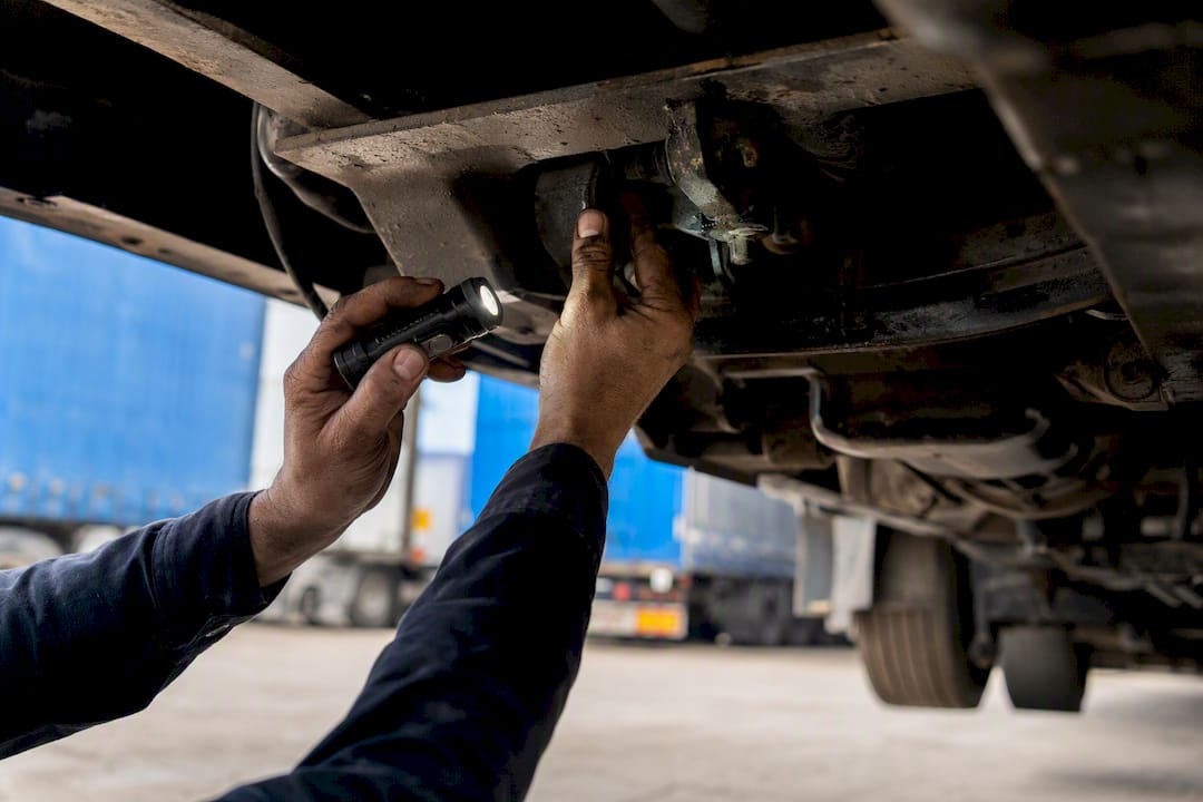 Hands inspecting vehicle maintenance details