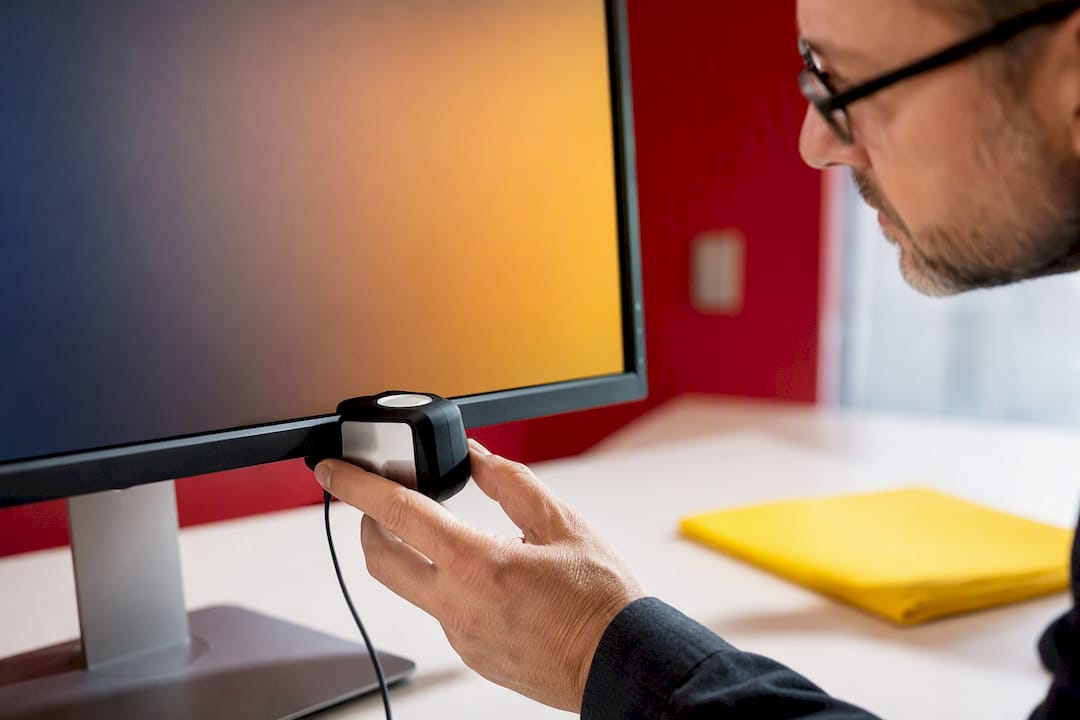 Color calibration sensor attached to monitor