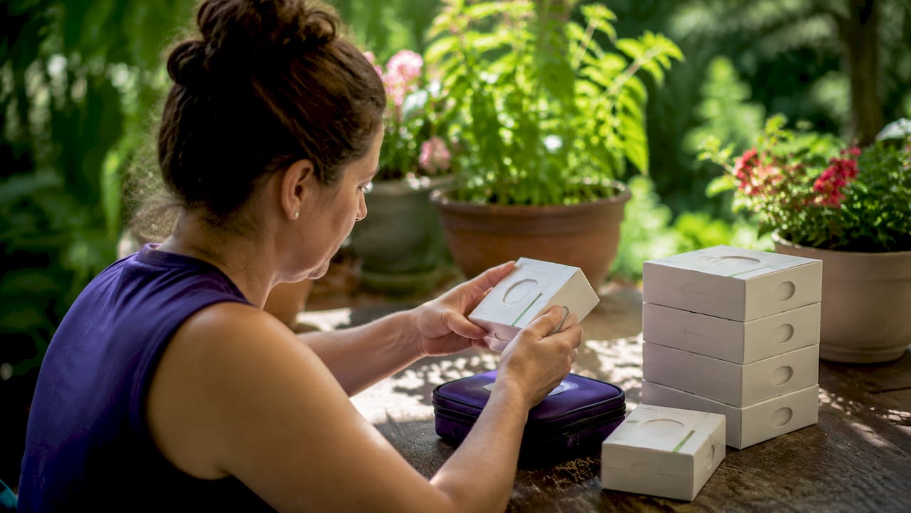 Hands inspecting sealed diabetic supply box