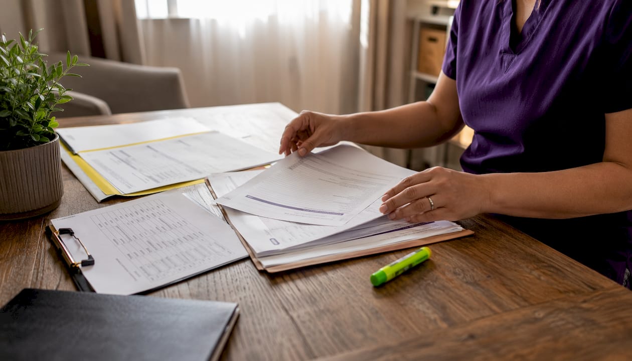 Hands organizing insurance and clinical documents
