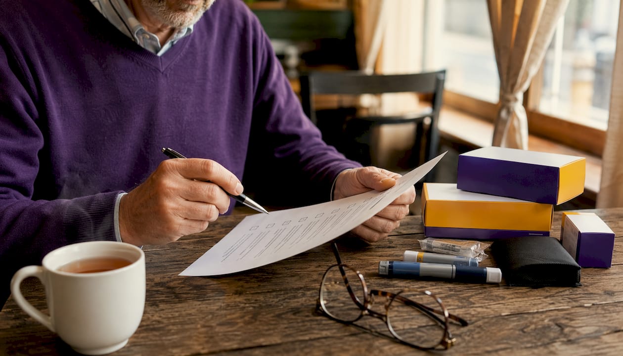 Hands checking insurance verification with diabetic supplies