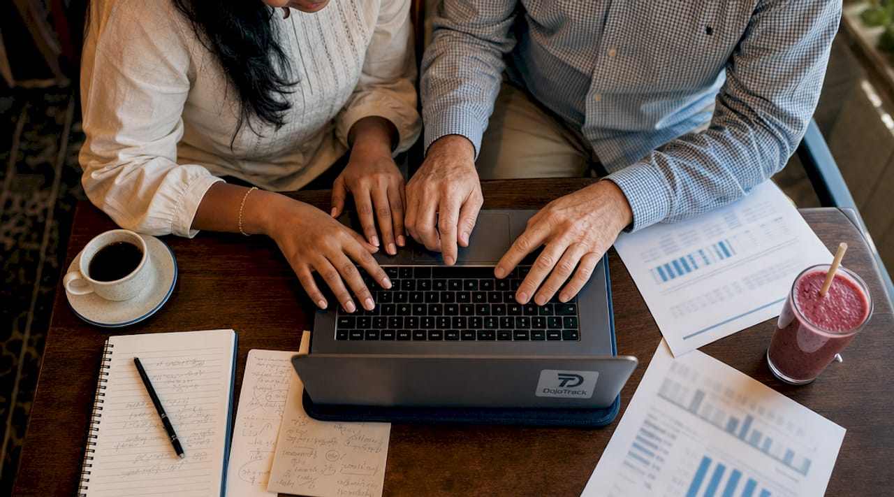 Hands auditing MMA billing data on laptop and papers