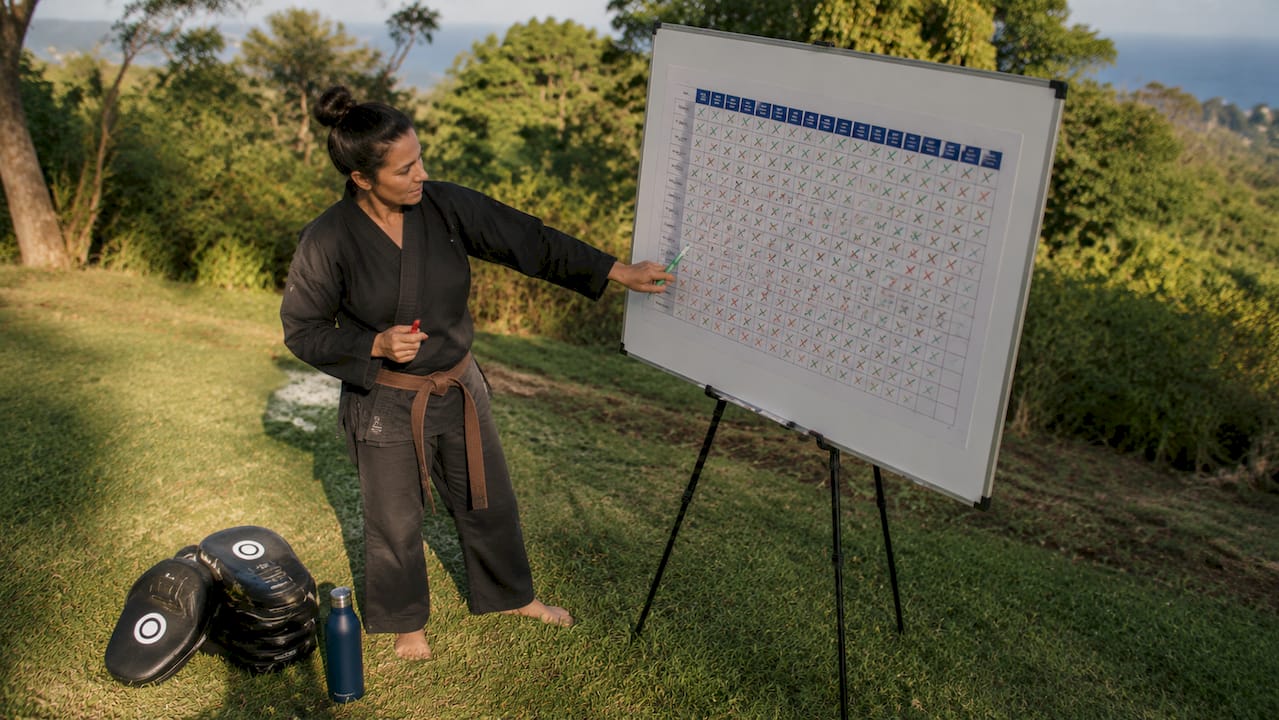 Instructor pointing to class attendance chart