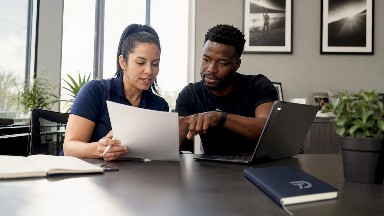 Staff coordinating lead follow-up strategy at MMA gym