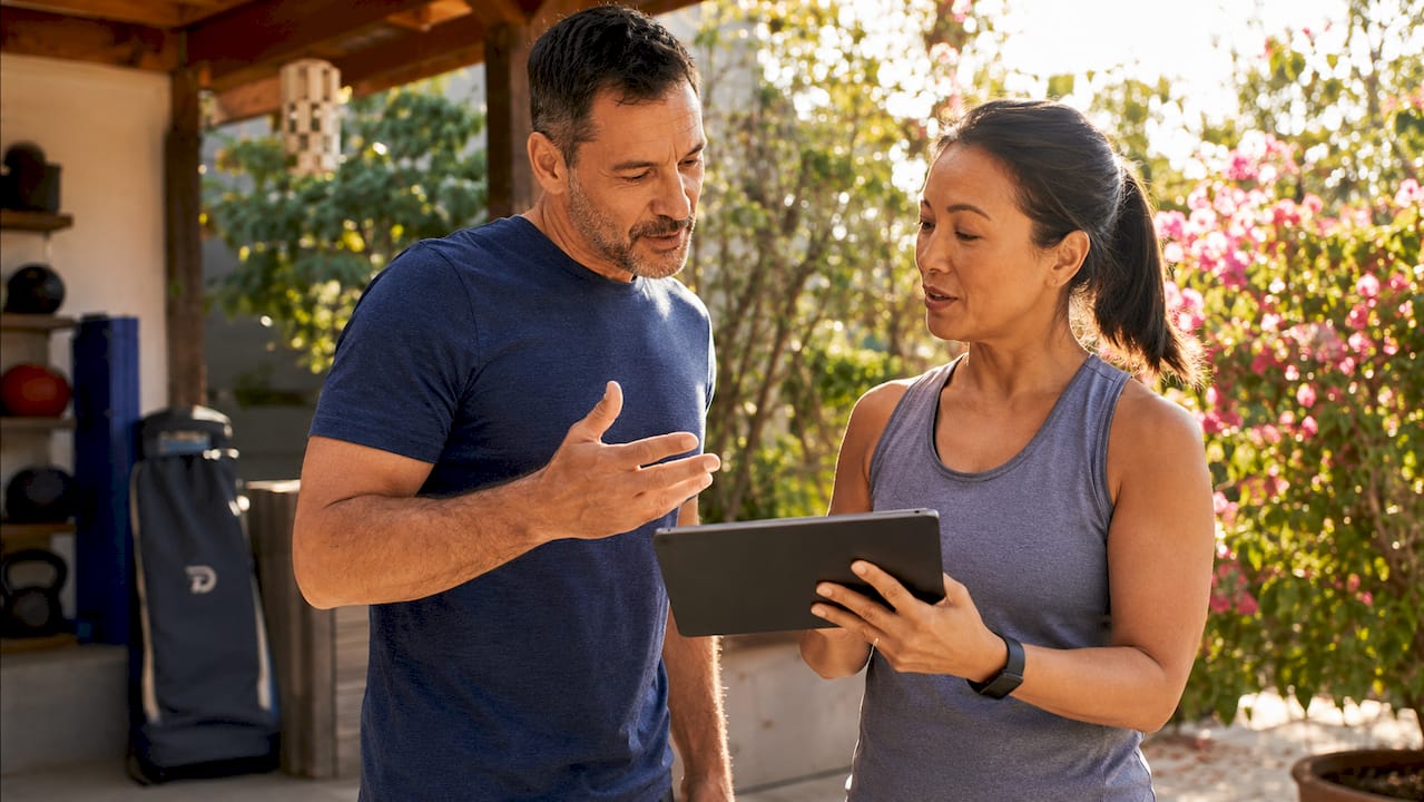 Instructors discussing payment methods on tablet