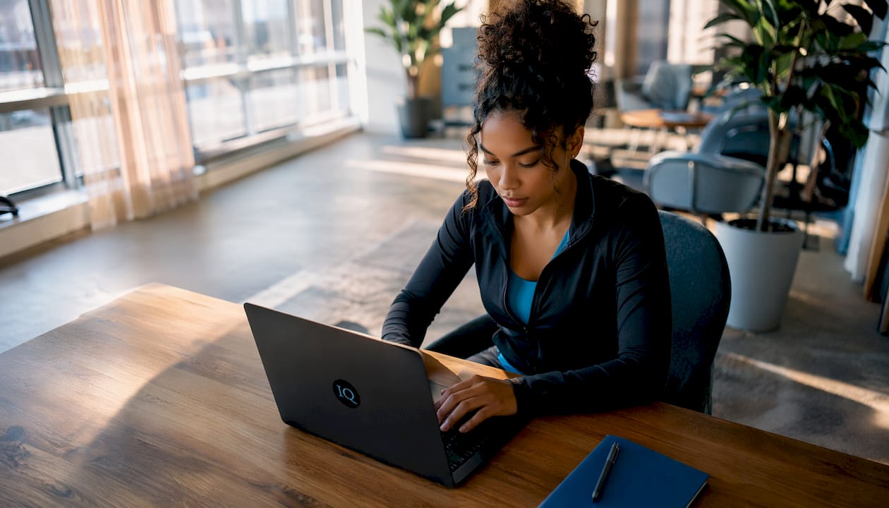 Woman typing laptop in home office