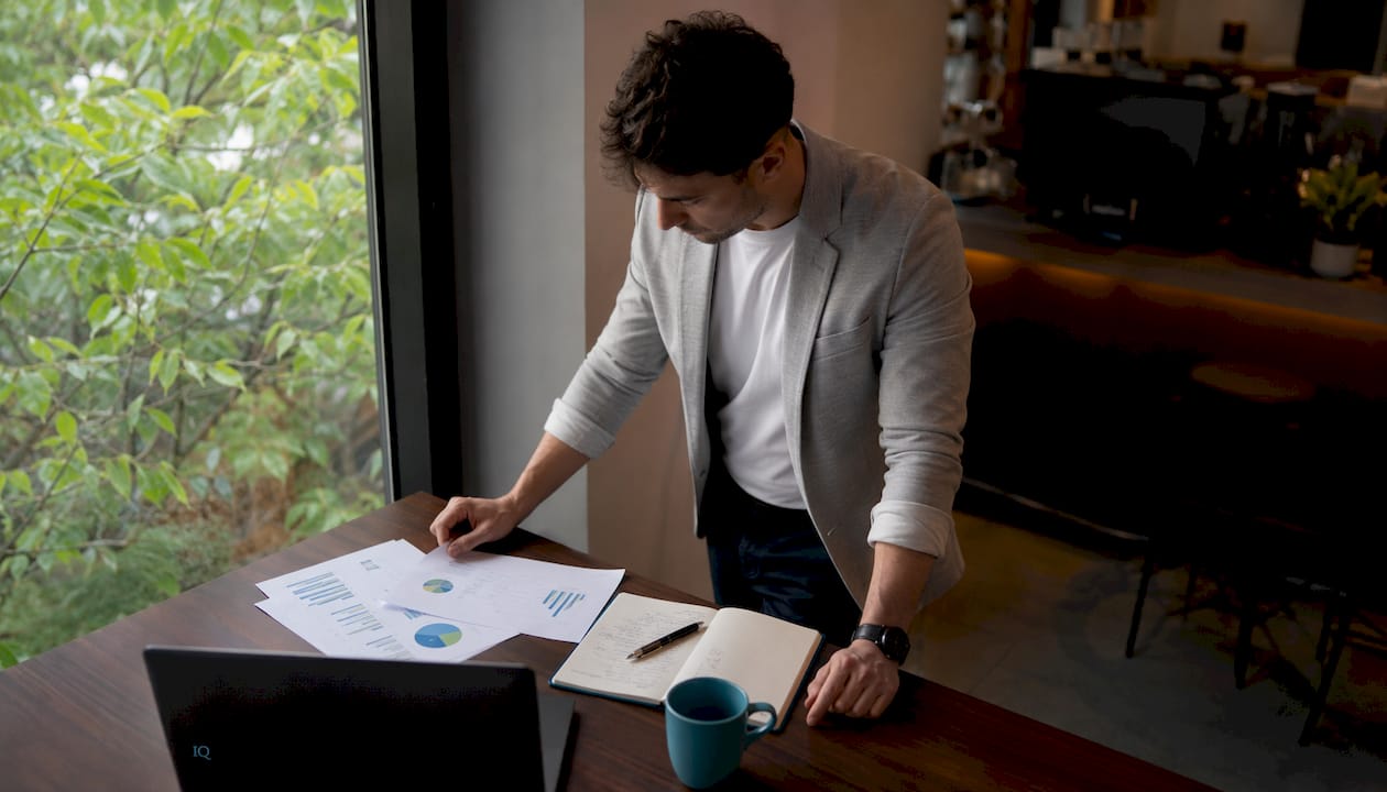 Solo founder reviewing idea validation materials in home office