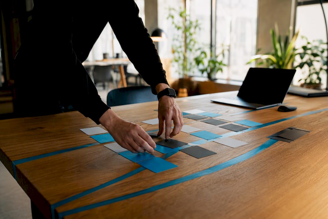 Hands arranging customer cohort cards