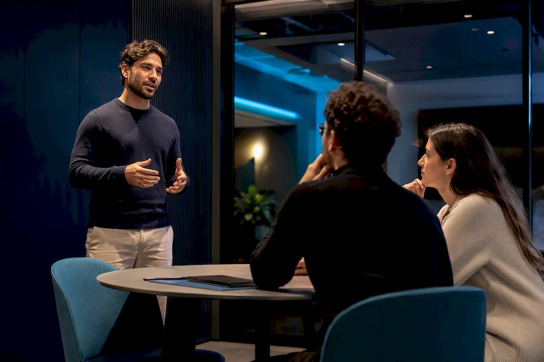 Founder delivering pitch to attentive listeners