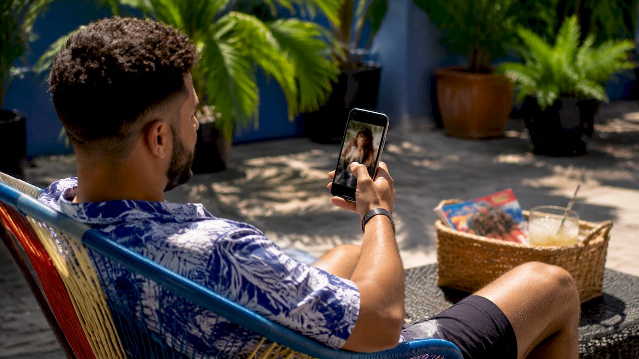 Young man scrolling salon videos on smartphone