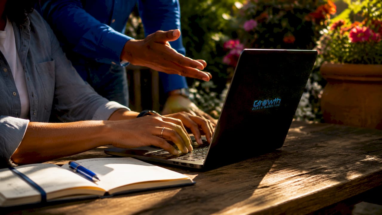 Hands typing on laptop with planner nearby