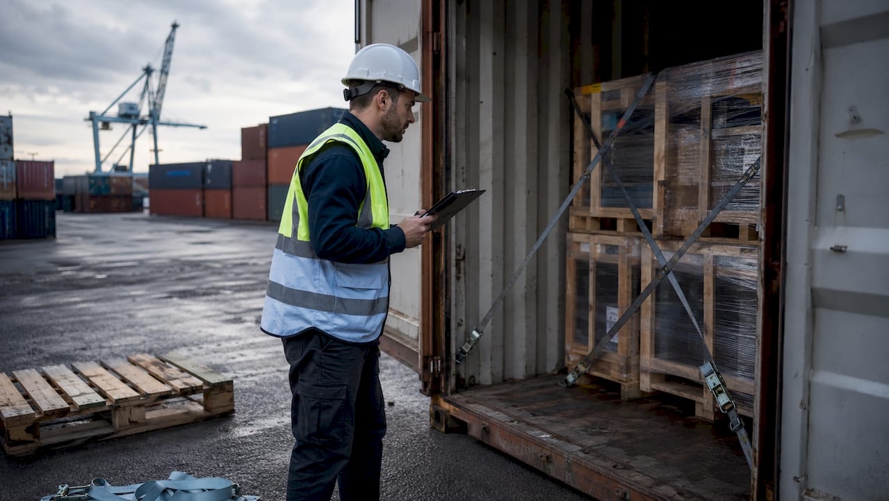 Logistics coordinator inspecting container loading at UK port