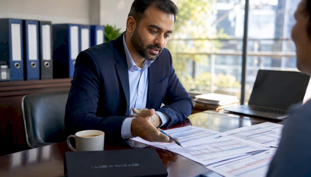 Logistics planner reviewing shipment schedules at office table