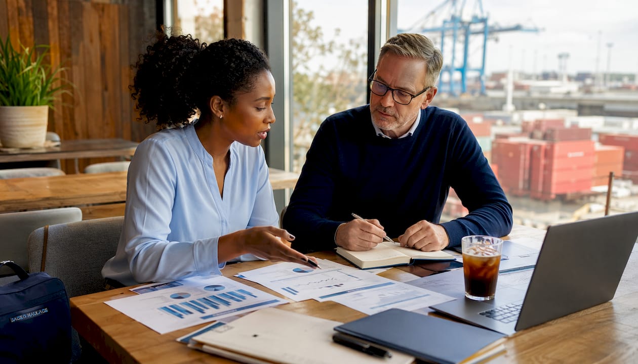 Two logistics experts comparing freight operations