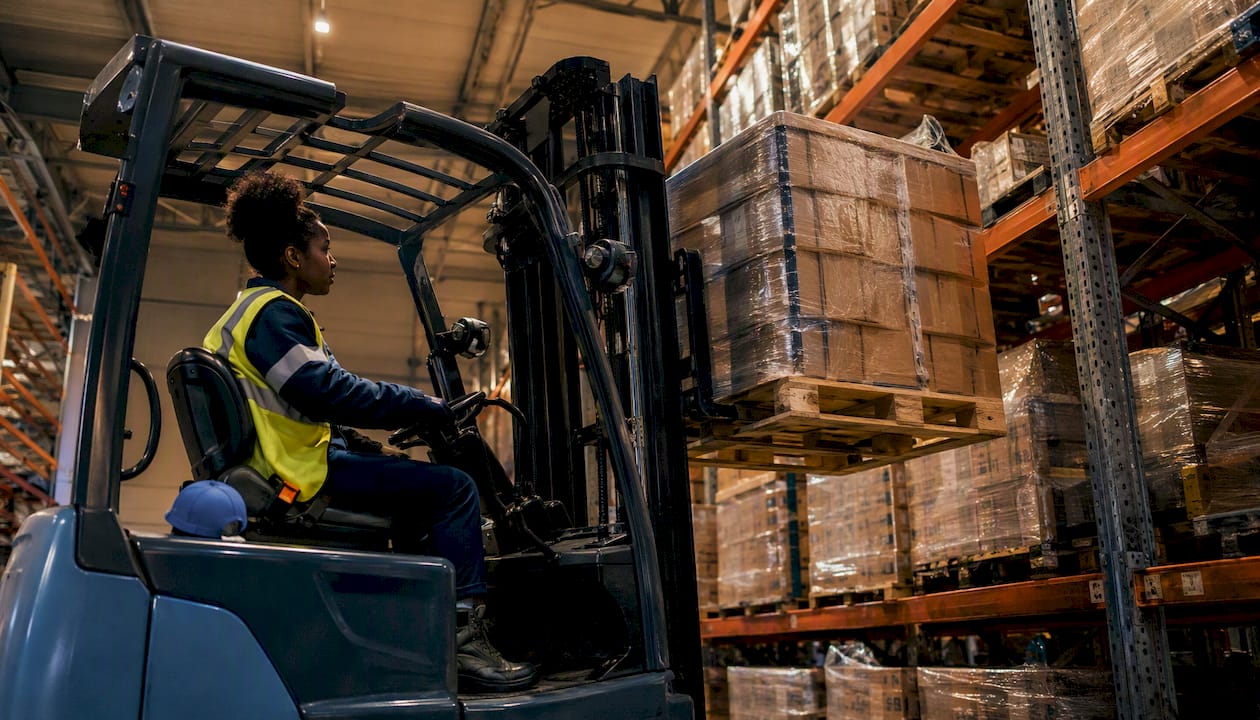 Forklift placing pallet on selective racking