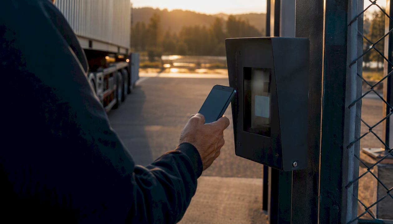 Truck driver scanning QR code at port gate