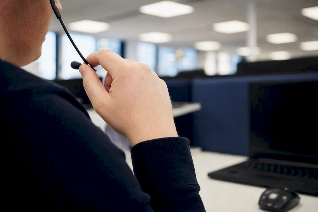Hands holding headset microphone at port CSC desk