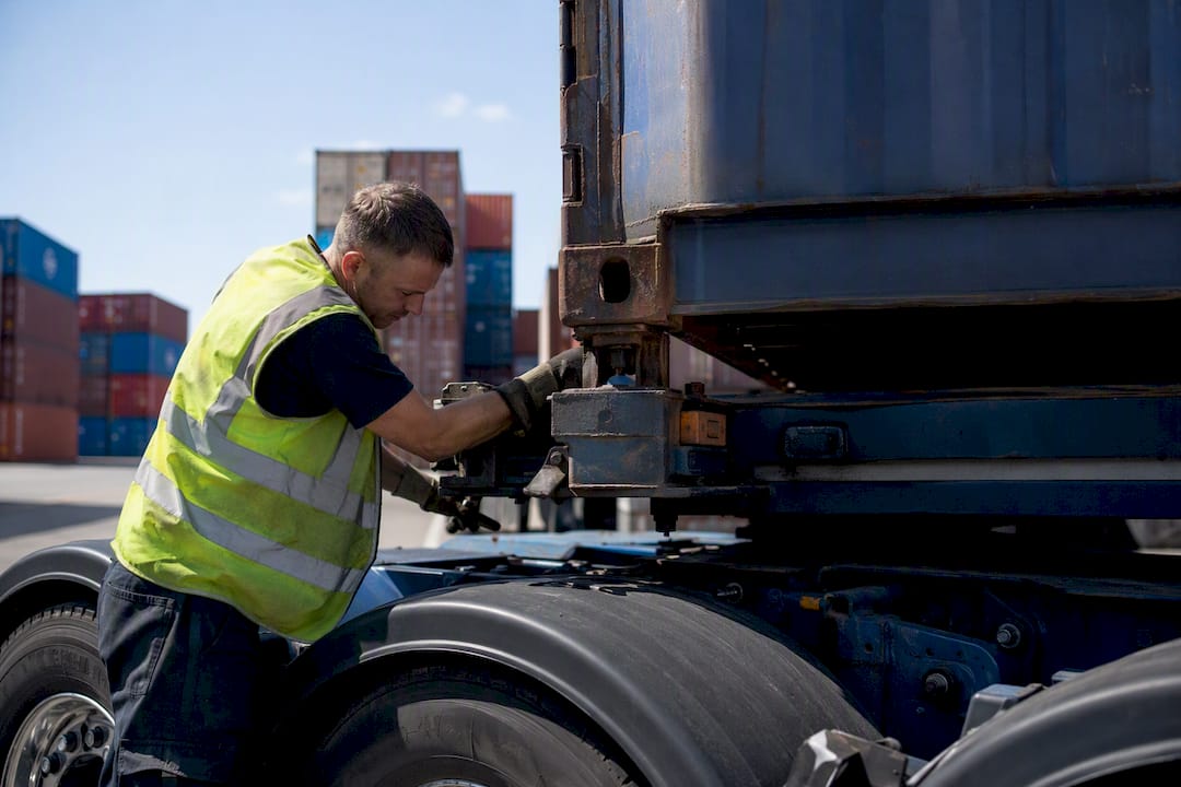 Haulage driver securing container locks in yard
