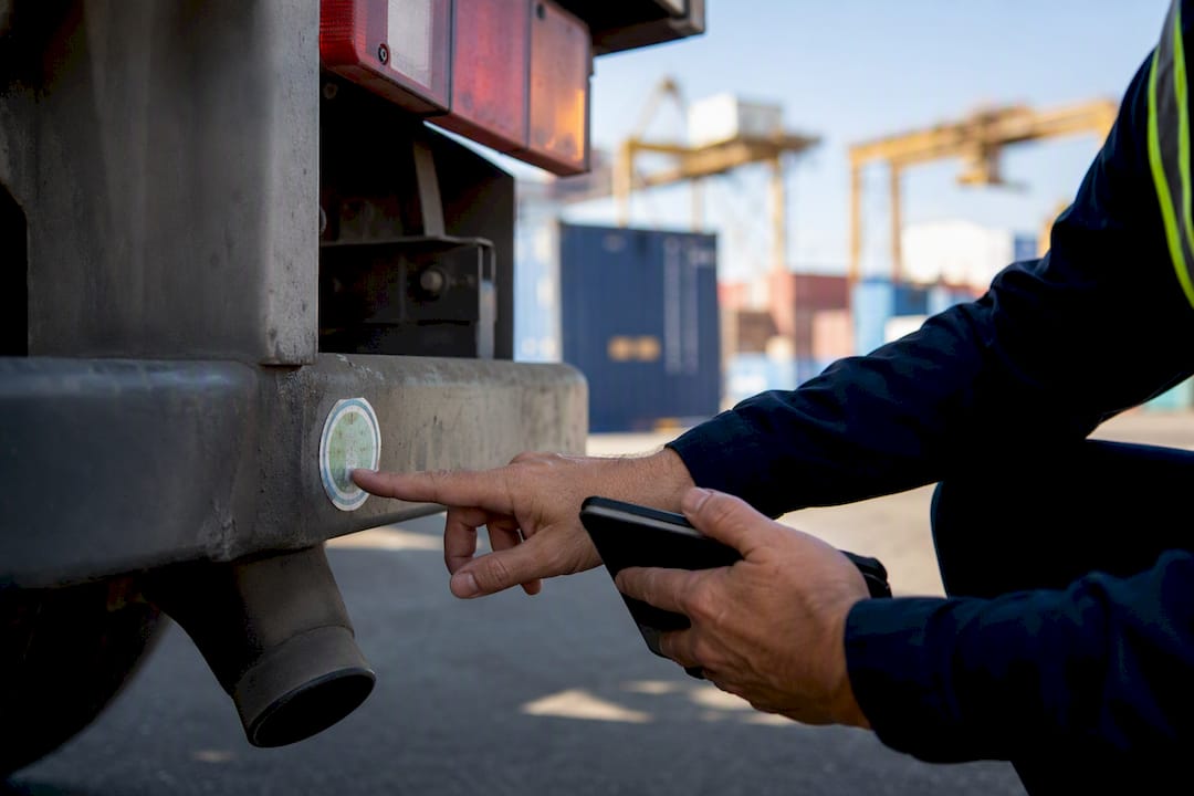 Hands checking truck compliance sticker
