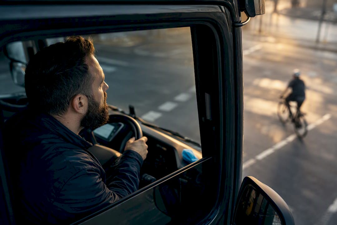Driver viewing cyclist from lorry cab