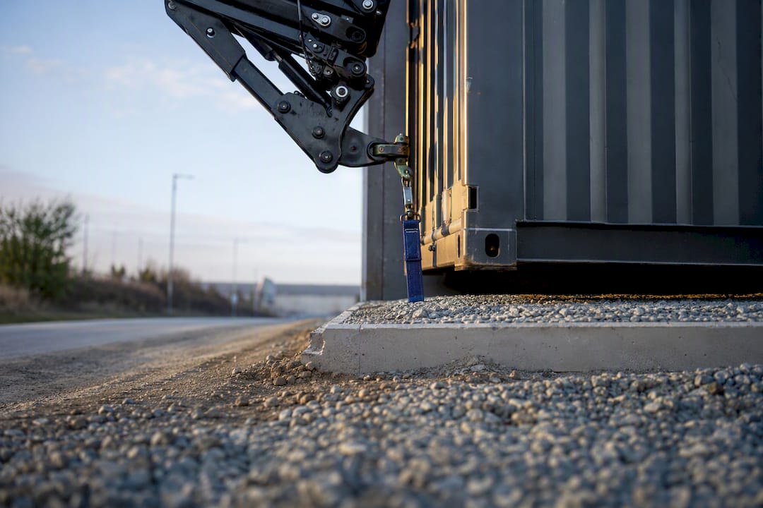 HIAB crane positioning container at UK delivery site