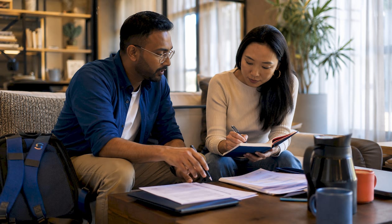 Two educators reviewing teaching abroad documents collaboratively