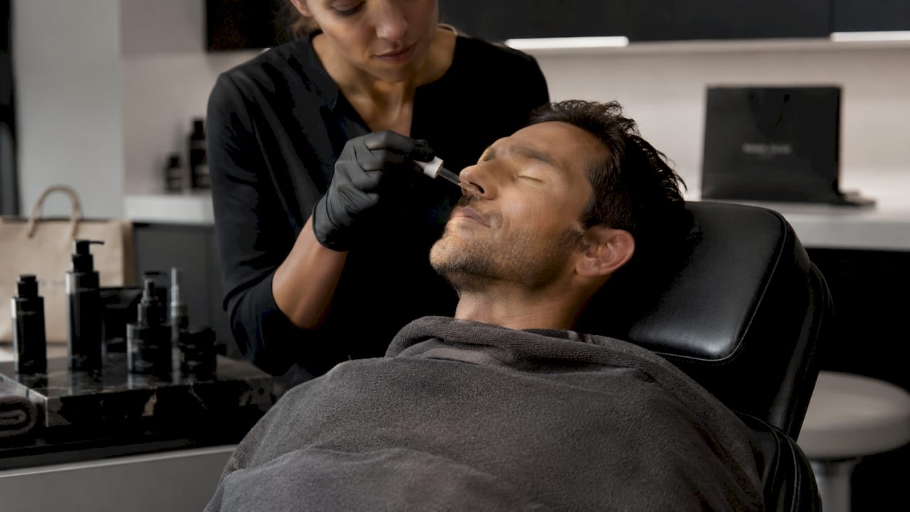 Close-up of male skin treatment application