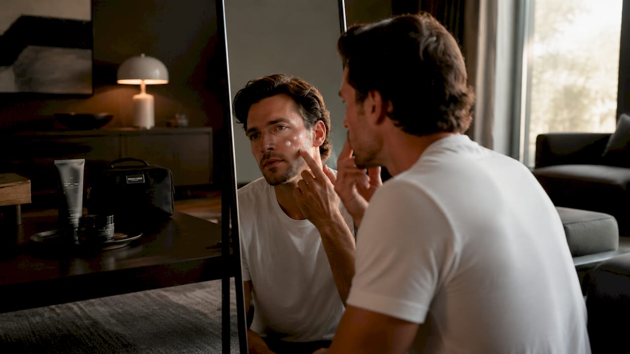 Man applying topical cream on face for rosacea