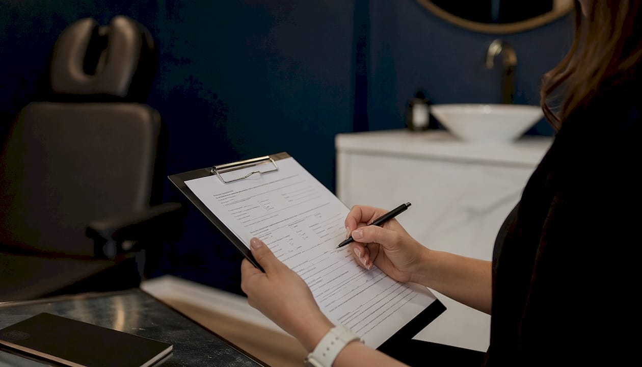 Clinician reviewing patient medical history form