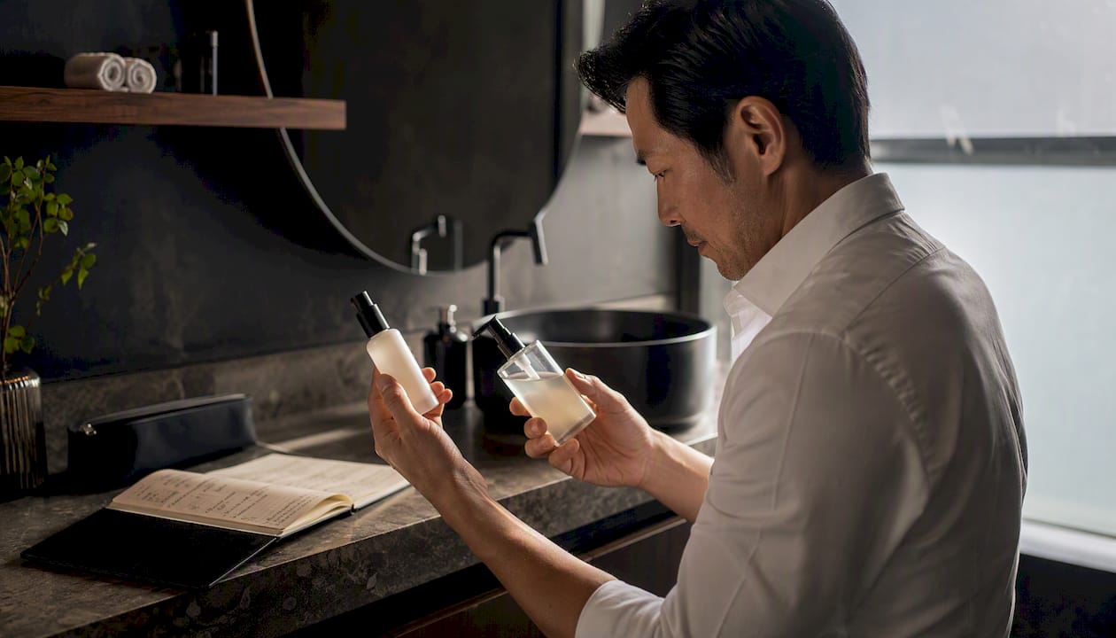 Hands sorting skincare products for combination skin