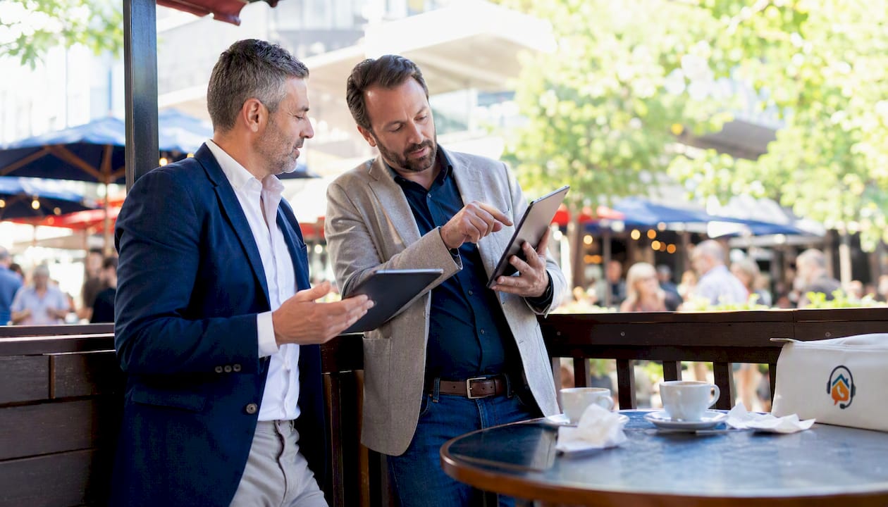 Salon managers discussing phone tools over laptops