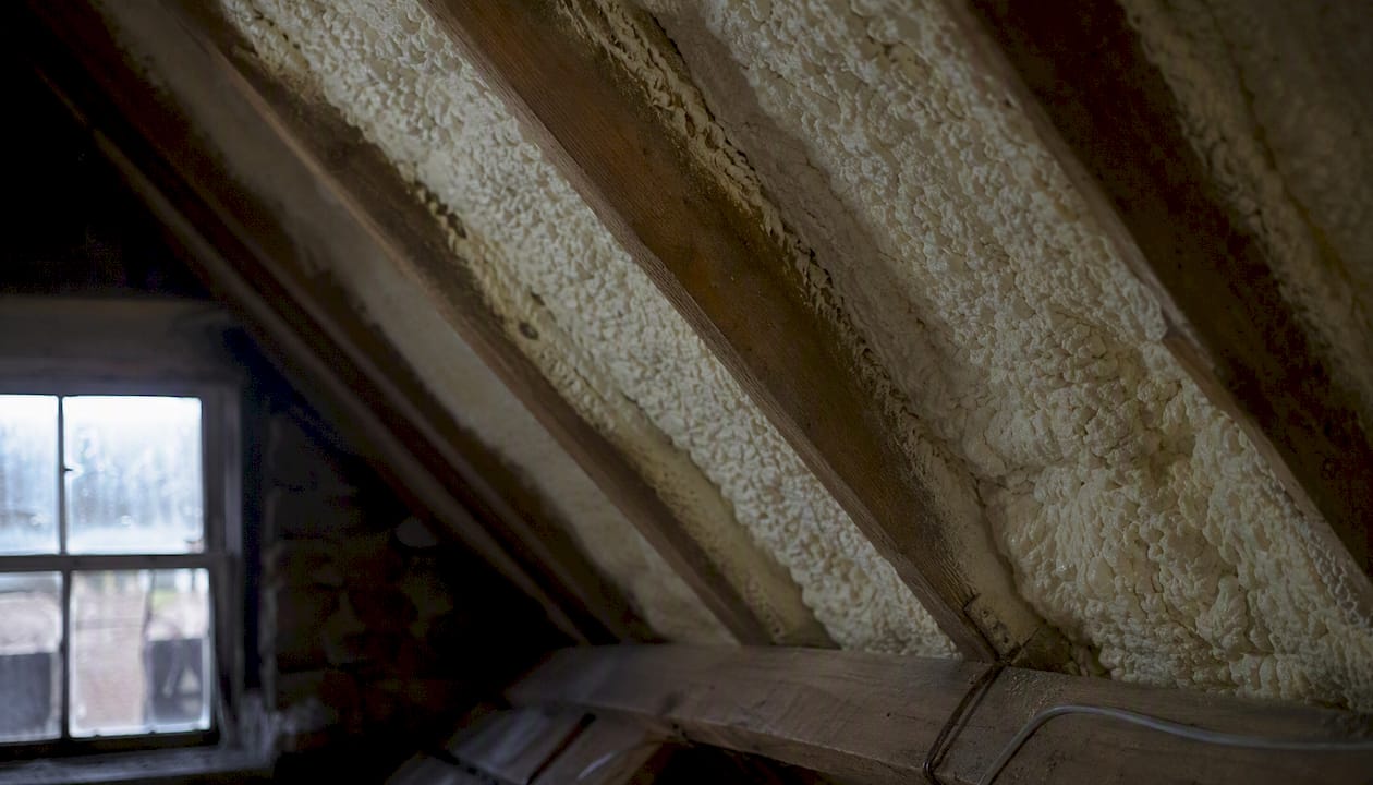 Open-cell foam insulating timber rafters in attic