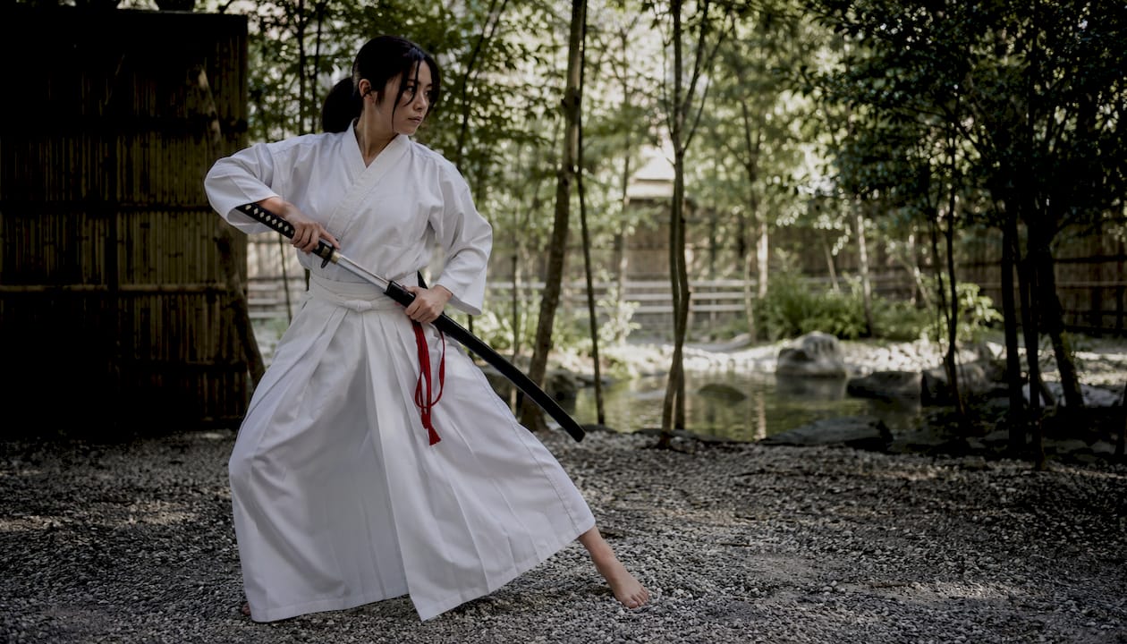 Iaido practitioner drawing shinken sword in dojo