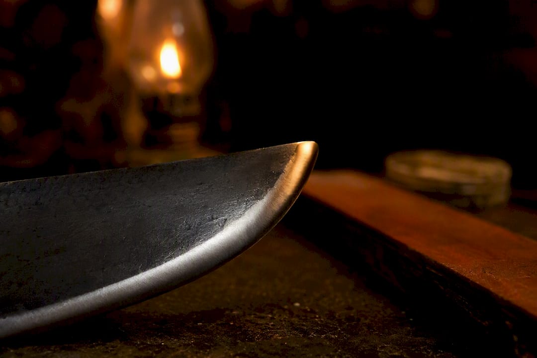Close-up of convex grind blade edge with polishing tools