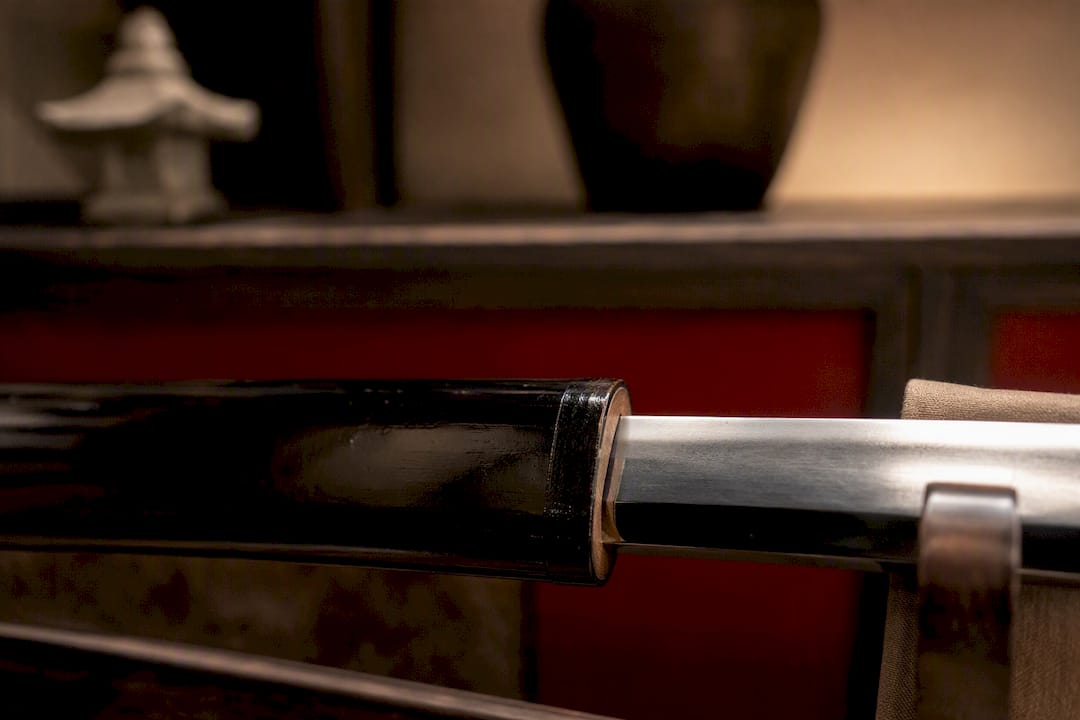 Close-up tight saya koiguchi and katana blade fit
