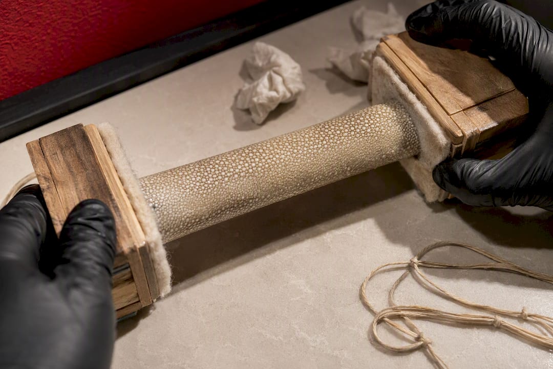 Padded clamps compressing wet samegawa wrap